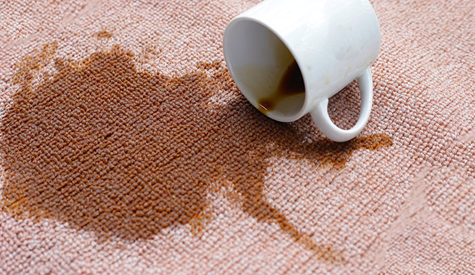 A coffee spill creating a significant stain on carpet