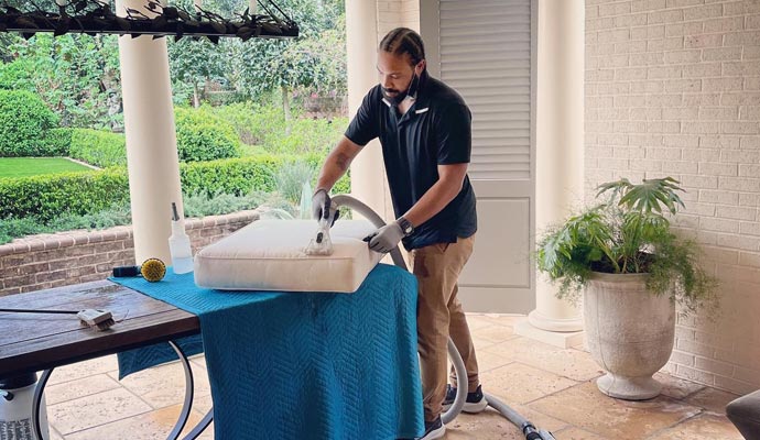 A person is cleaning couch